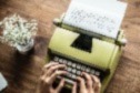 Photo of someone typing on a typewriter